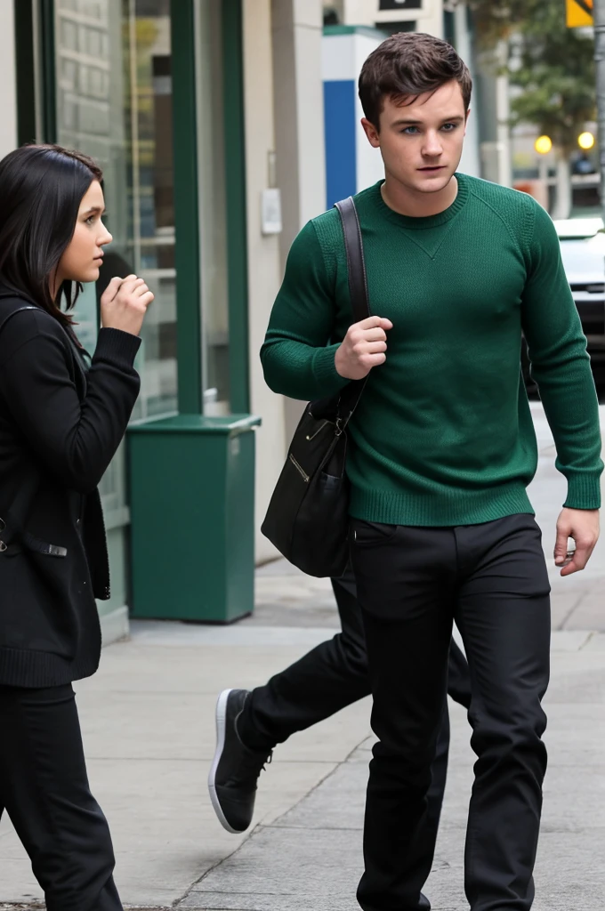 Josh Hutcherson wearing green sweater, black pants, scared