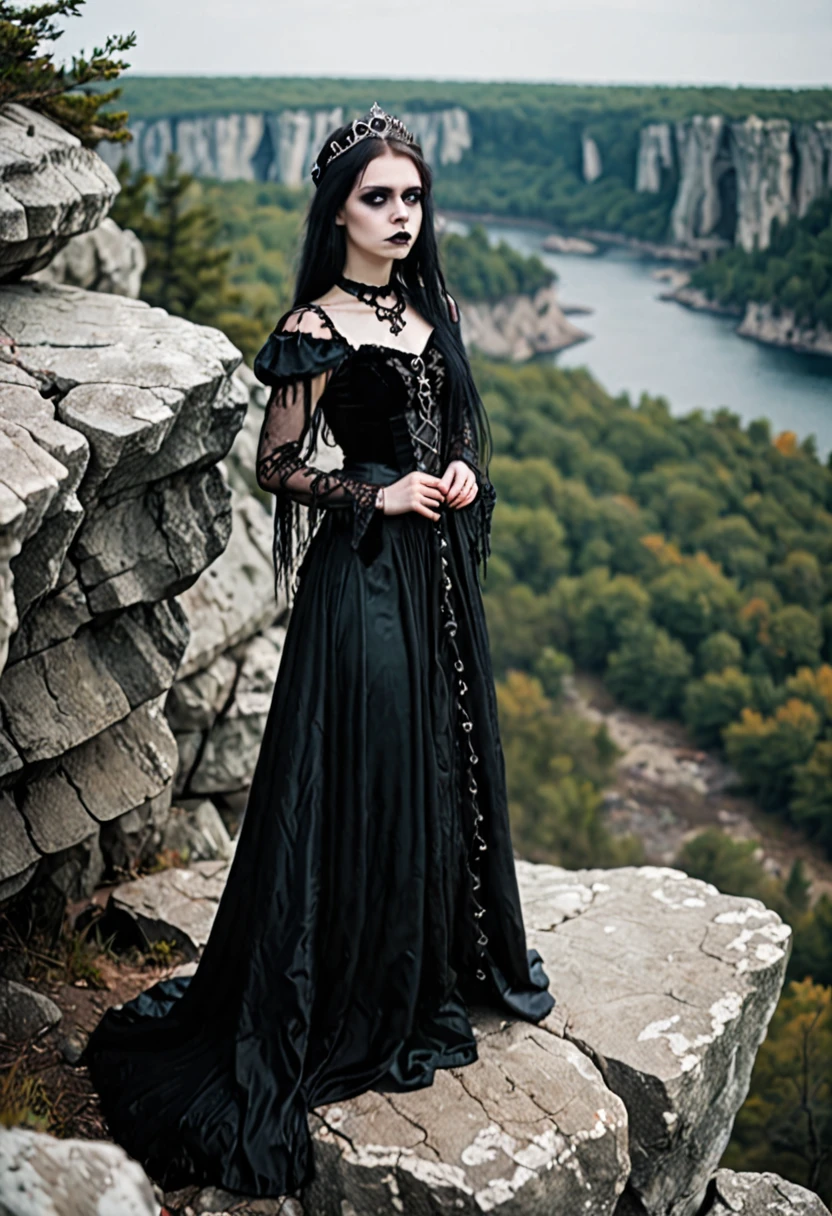 Gothic princess standing on a rocky cliff