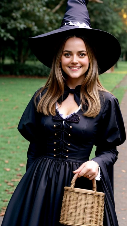 Alicia Silverstone dressed in traditional witch clothing and smiling