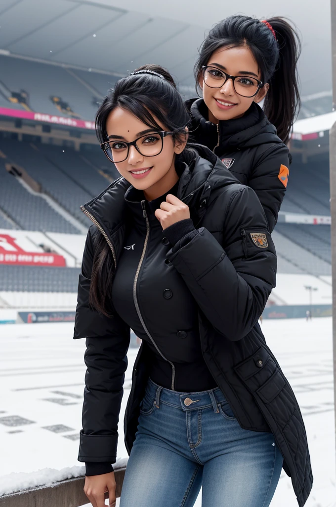 beautiful 25 year old woman from New Delhi, black ponytail hair, very attractive, smile, toned athletic body, wearing glasses, at snowy football stadium wearing jeans and coat
