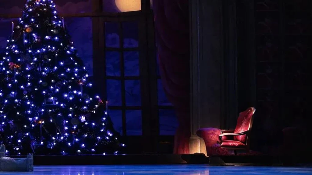 a chair in front of a christmas tree, media photo, foreground background, footage of a theater stage, press photos, holiday season, ( ( emma lindstrom ) ), musical, full image, background image, beautifully, trending photo, !!beautiful!!, cutest, photo still