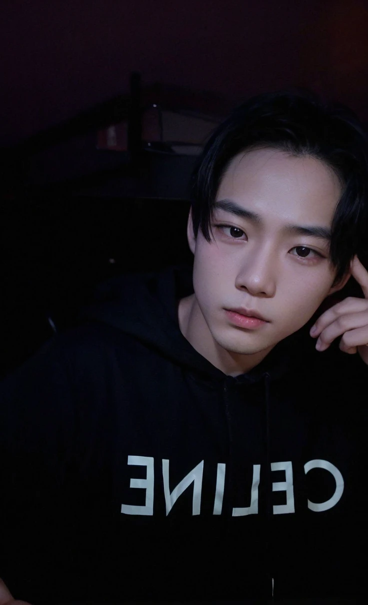 Asian boy in a dark room