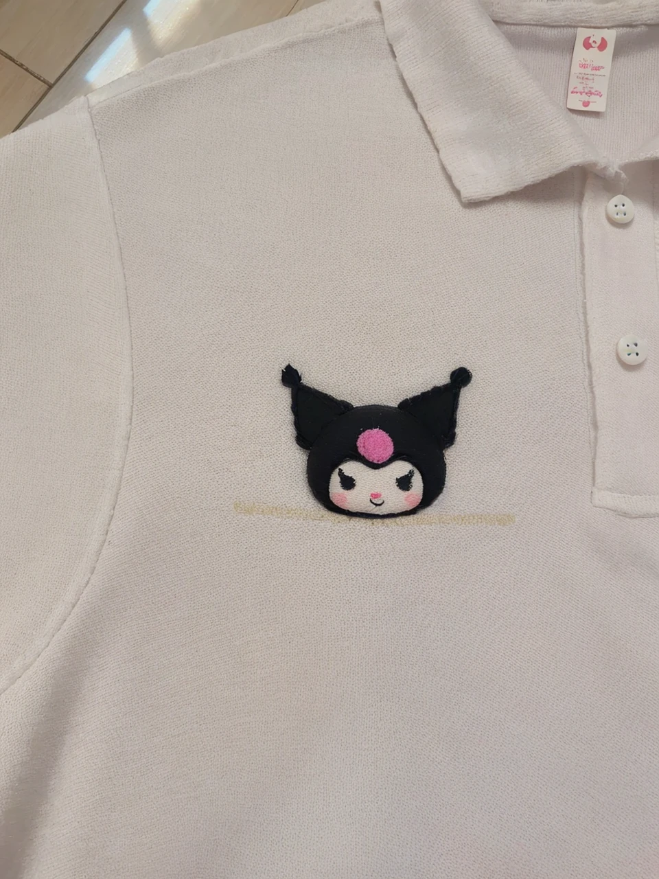 a cute and adorable kuromi mascot character, white fluffy dress, cute face, big eyes, small nose, pink cheeks, long eyelashes, detailed facial features, adorable expression, high quality, digital art, illustration, pastel colors, soft lighting, highly detailed, photorealistic, 4k
