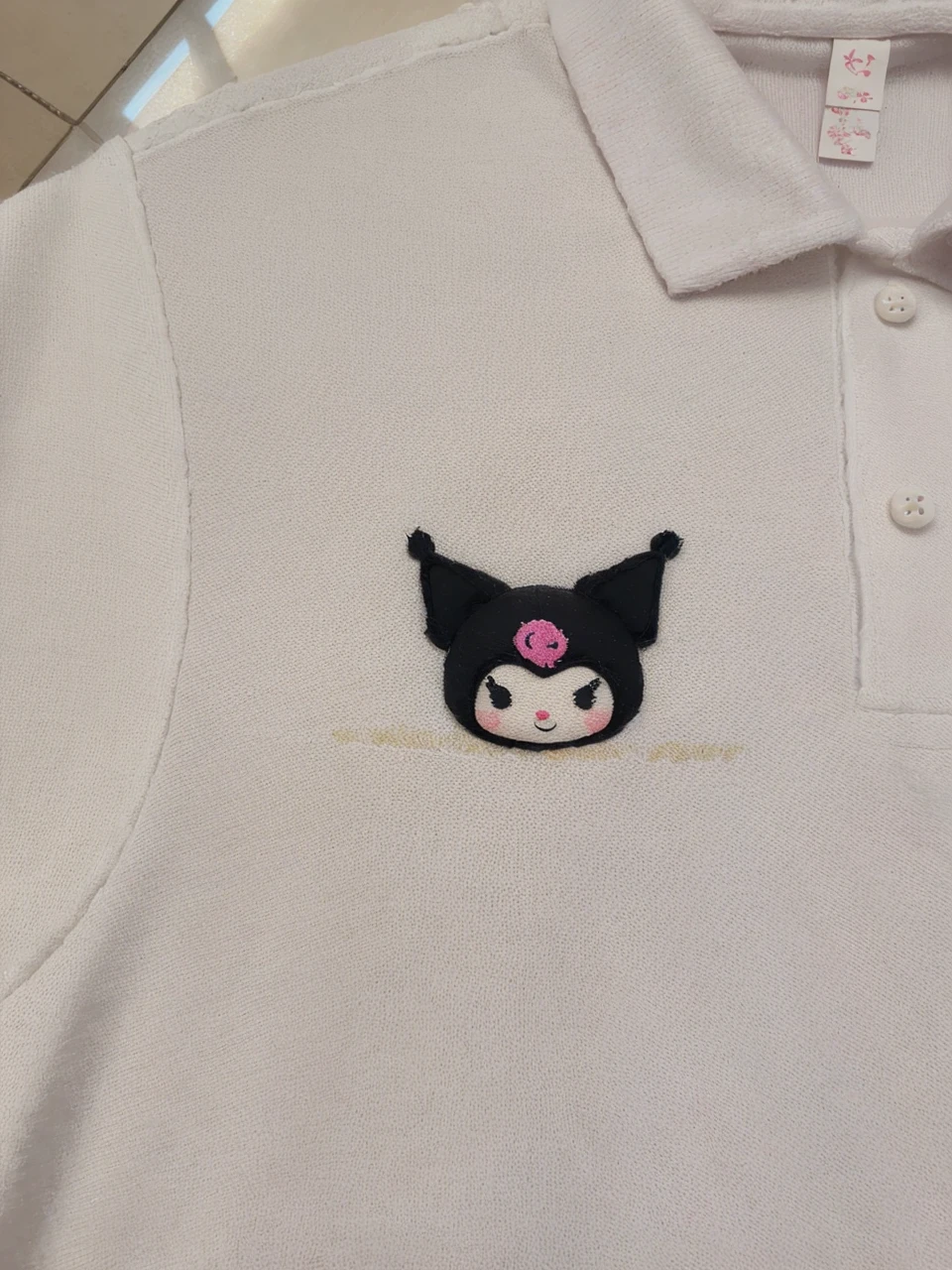 a cute and adorable kuromi mascot character, white fluffy dress, cute face, big eyes, small nose, pink cheeks, long eyelashes, detailed facial features, adorable expression, high quality, digital art, illustration, pastel colors, soft lighting, highly detailed, photorealistic, 4k