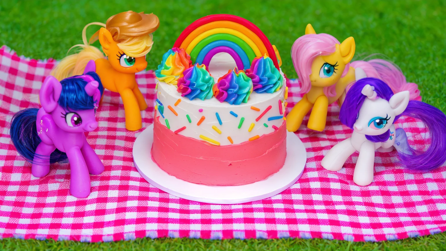 on the grass, on a pink checkered tablecloth. there is a white plate with cake, white and pink cream cake, Rainbow confectionery powder on the cake, top rainbow gradient cream, polymer clay rainbow, рядом стоят пластиковые pony toys из мультфильма My Little Pony, pony toys, beautiful light, sunlight, sunny day, beautiful lighting, bright announcement, several light sources, Realistic style, realistic textures, high quality, high detail, detailed texture, ultra 4k hd