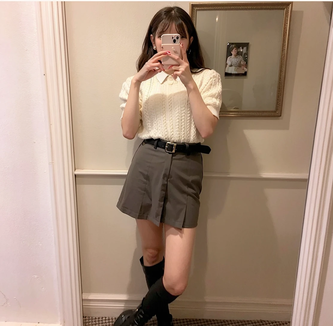 debris flies、highest quality、super fine、Understood、High resolution、8k wallpaper、perfect dynamic composition、(((Full body Esbian)))、((from below))、20 year old cute girl、detailed beautiful face、delicate and cute eyes、fine-textured skin、My cheeks turned red、(wavy black hair)、thin legs、Please generate at the eaves、Take a selfie with your phone、room、Wearing short-sleeved knitwear、wear a skirt、white background、I can see your pants、panty shot