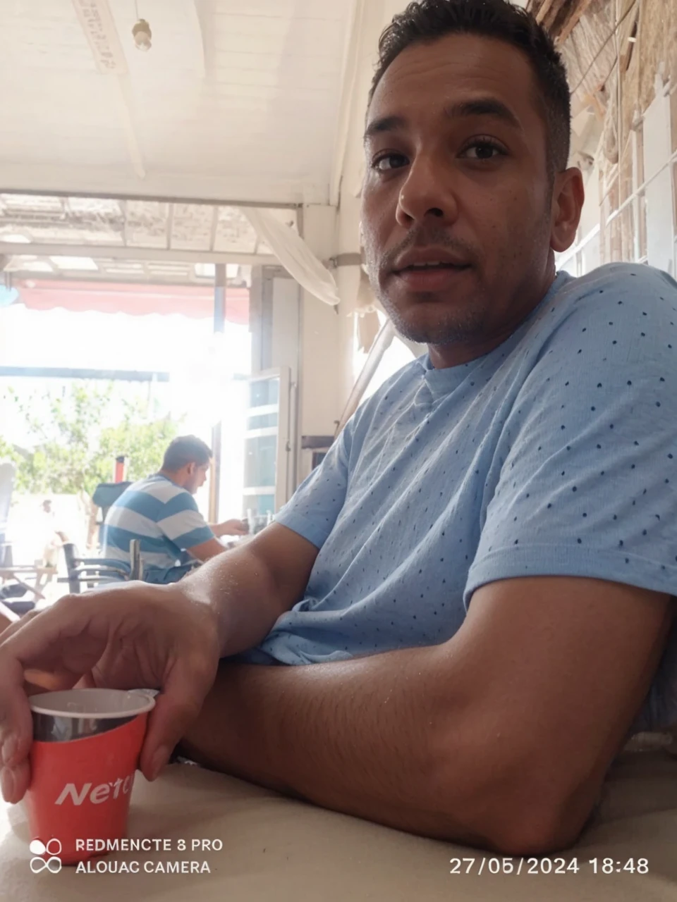 Change the background of this image and put this person on a beach.