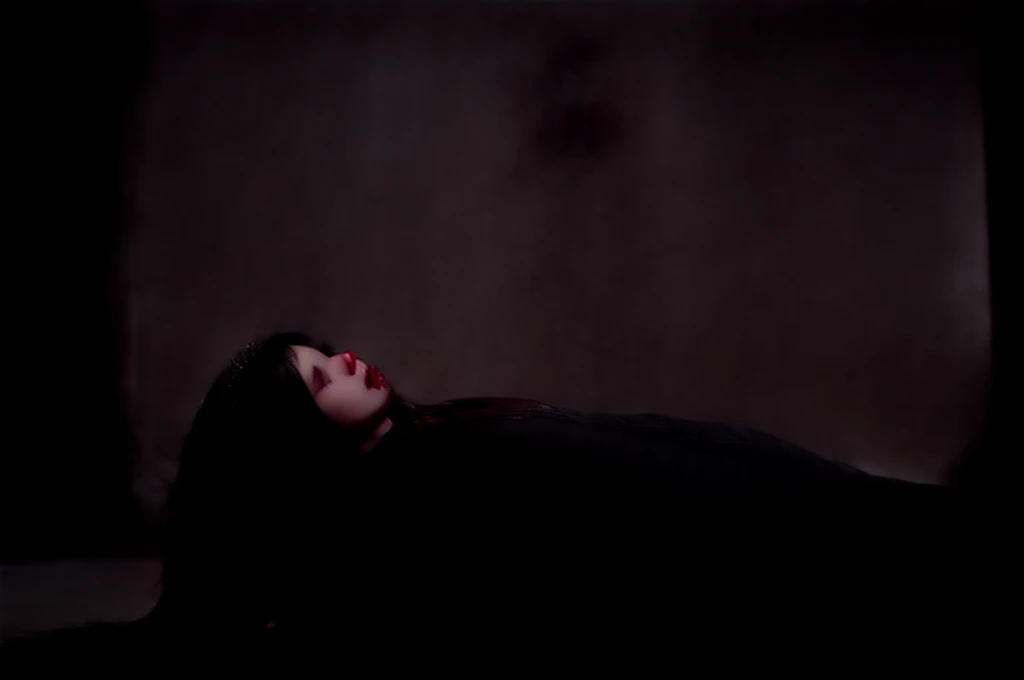 Haunting image of a dead priest (side view) lying on the floor of a Gothic cathedral. He is middle-aged, and wears simple vestments and a white Roman collar. Blood pools around him. Front view of a female vampire kneeling over his corpse, red tears that look like blood stream down her cheeks. Guilt from murdering the good priest haunts her. She places a single red rose on his chest. She wears an elegant black dress and a rosary around her neck. She has mournful red eyes, long clearly visible fangs, and long black hair hangs down her shoulders. Masterpiece quality, soft lighting