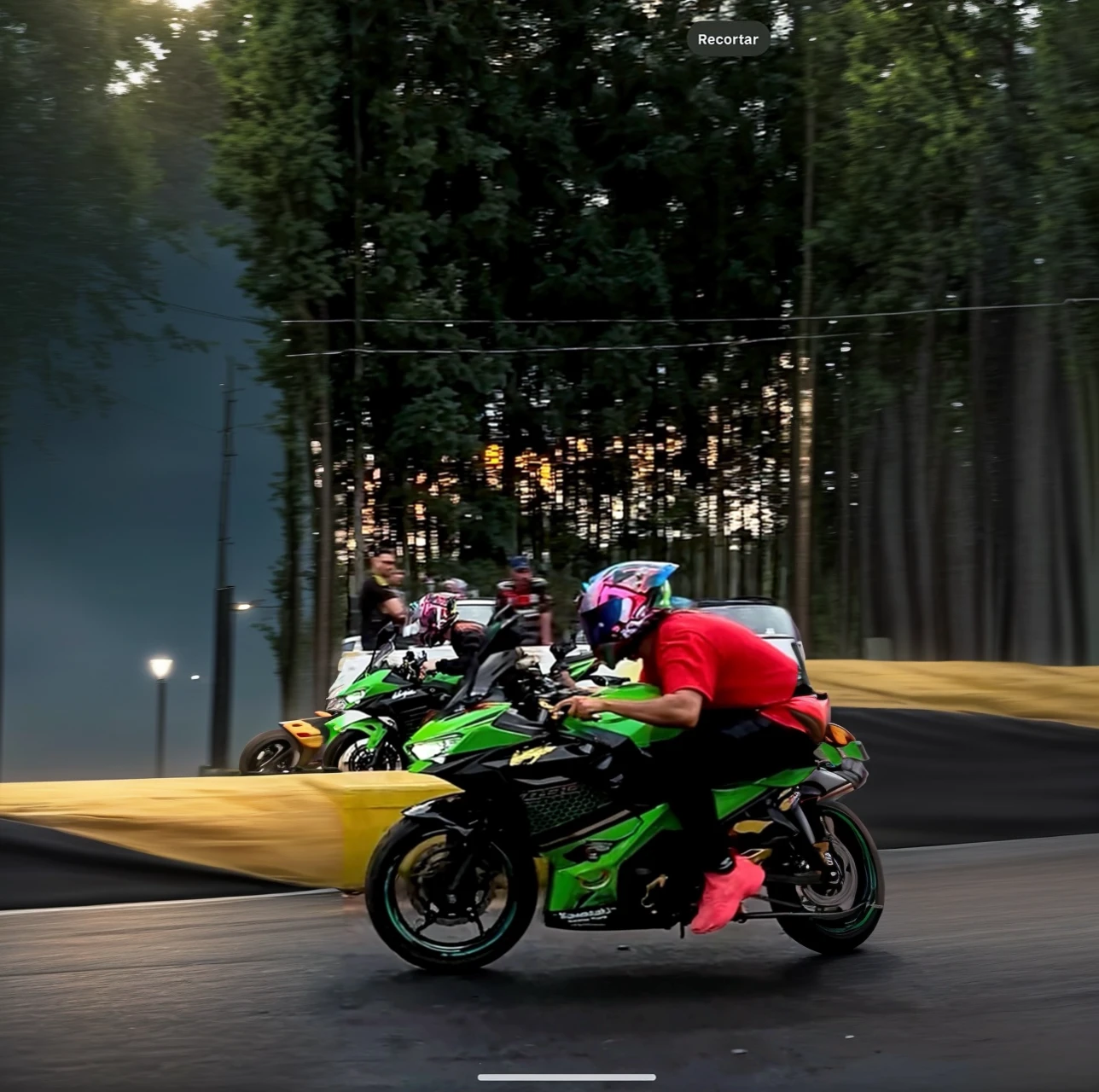 Two Kawasaki ninja 400cc motorcycles on a drag strip racing