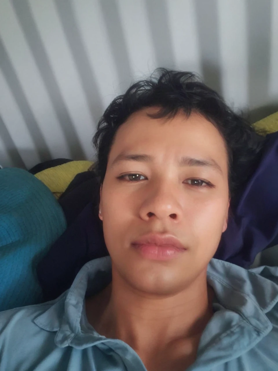 (RAW photo:1.2),(photorealistic:1.4),(masterpiece:1.3),(best quality:1.4),ultra high res, HDR,8k resolution, dreamlike, check commentary,commentary request,scenery,((no text)), solo focus, (detailed eyes),(detailed facial features), (detailed clothes features), skin tight, (shiny skin),(slender),(slim),(beautiful face), 1boy, VirtualGirl-Ren, young, bangs,black hair, blue eyes,ear studs, loose shirt, smile, bashfully,cute, look straight into the camera,