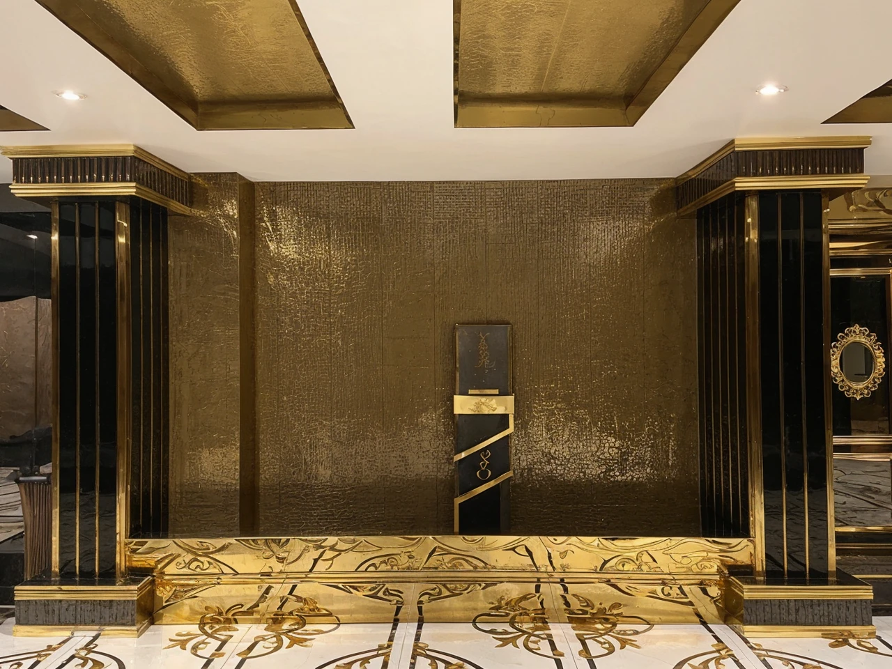 Wall design with golden glossy rose and plant with gold paint