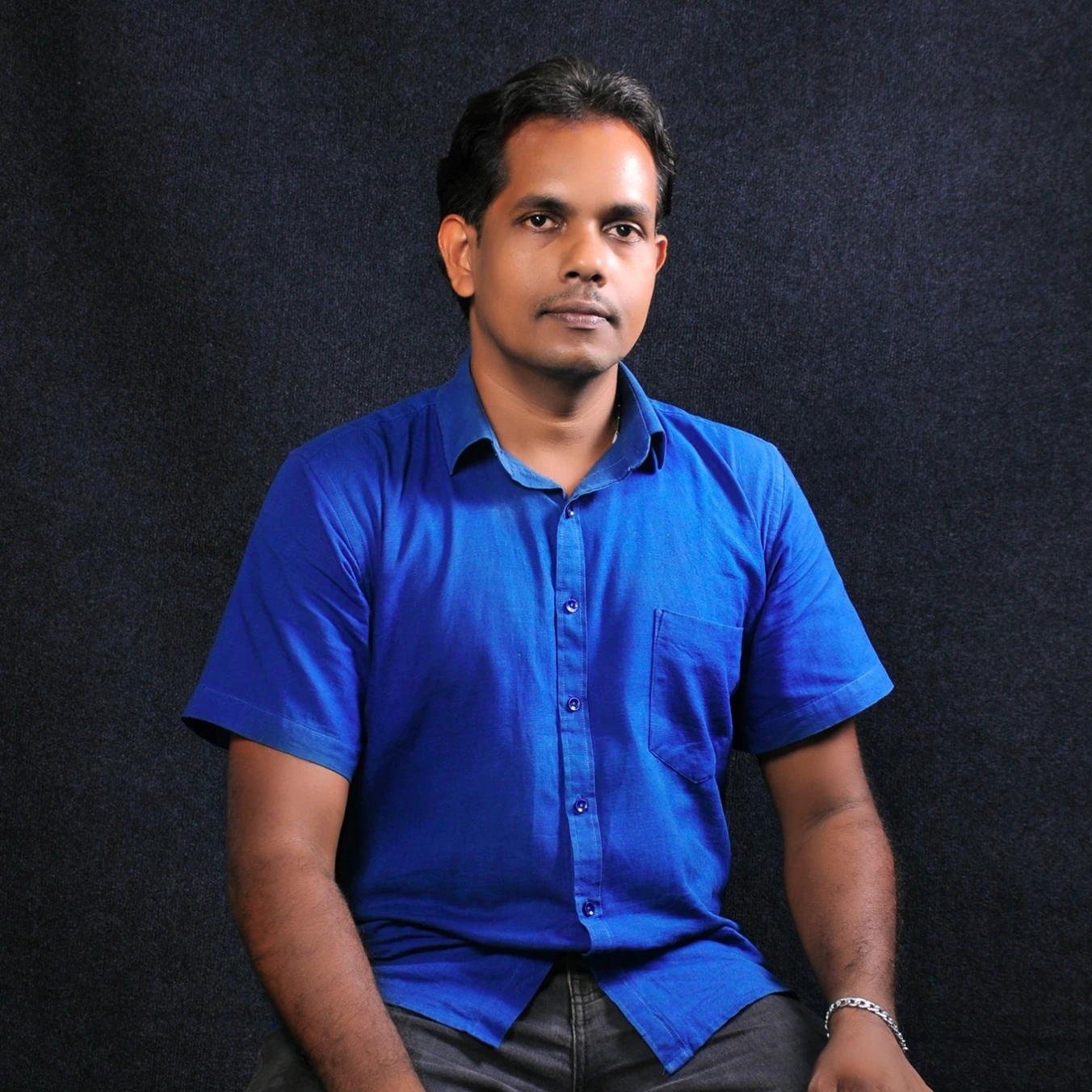 A common man wearing a blue shirt is sitting on a chair, Jason Devadas, He wore the photo, Vinayak, mohamed chahin, profile picture, Full body photograph, Jonathan Waichak, 8k portrait shot, By Max Dowthende, Alfonso Asperi, Full body snapshot, Full body photo