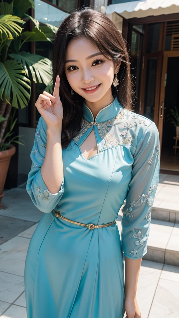 The woman in the kebaya raises her right thumb while smiling