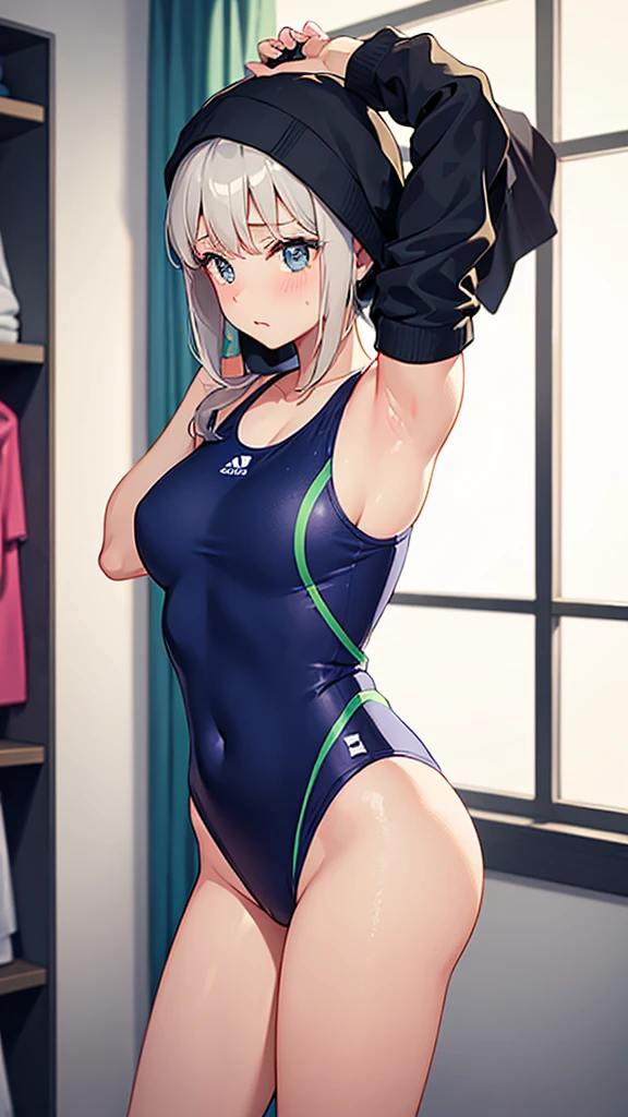 A girl in a changing room trying to change into a competitive swimsuit with a wrap towel around her
