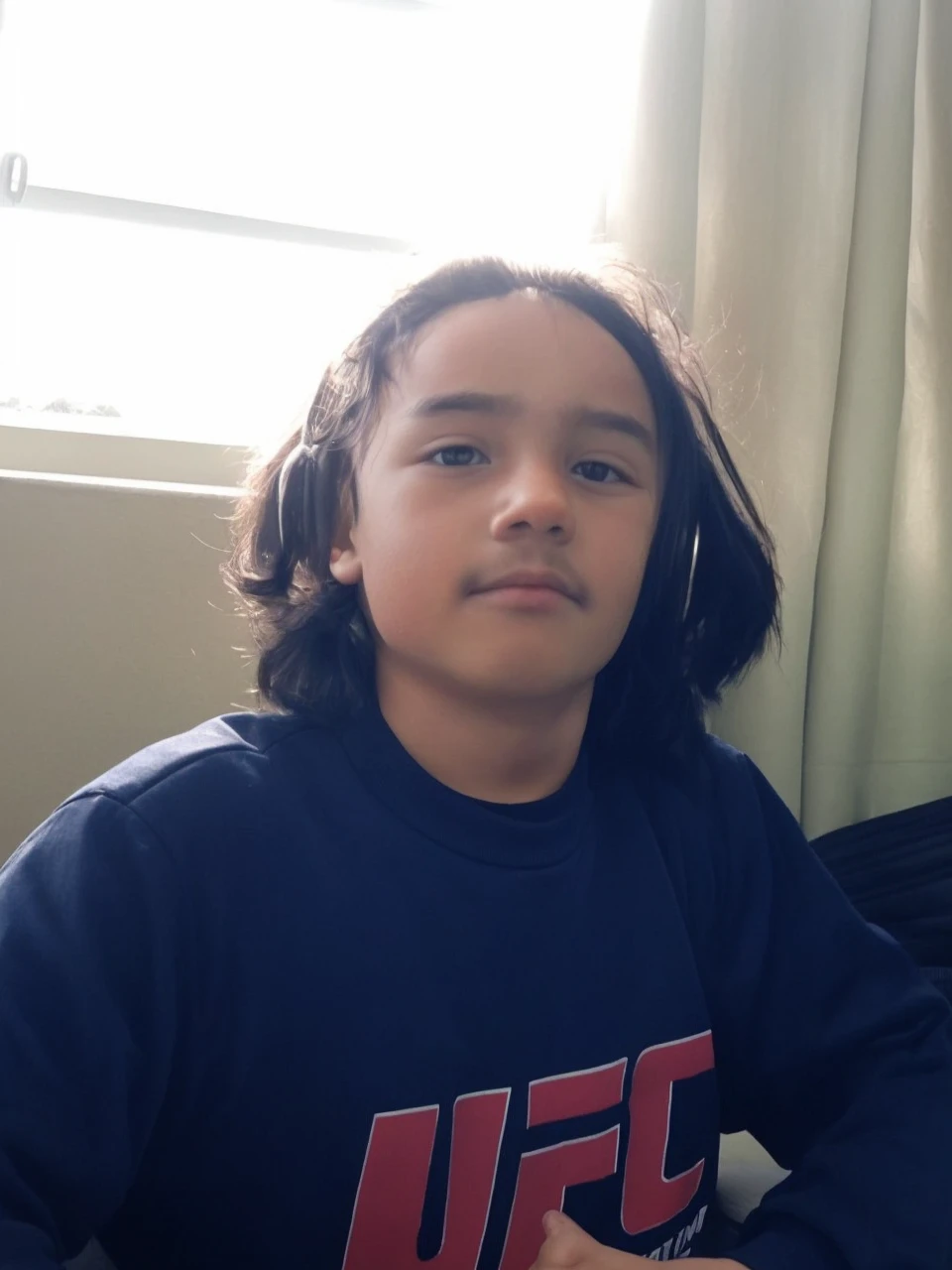 A boy with long black hair 