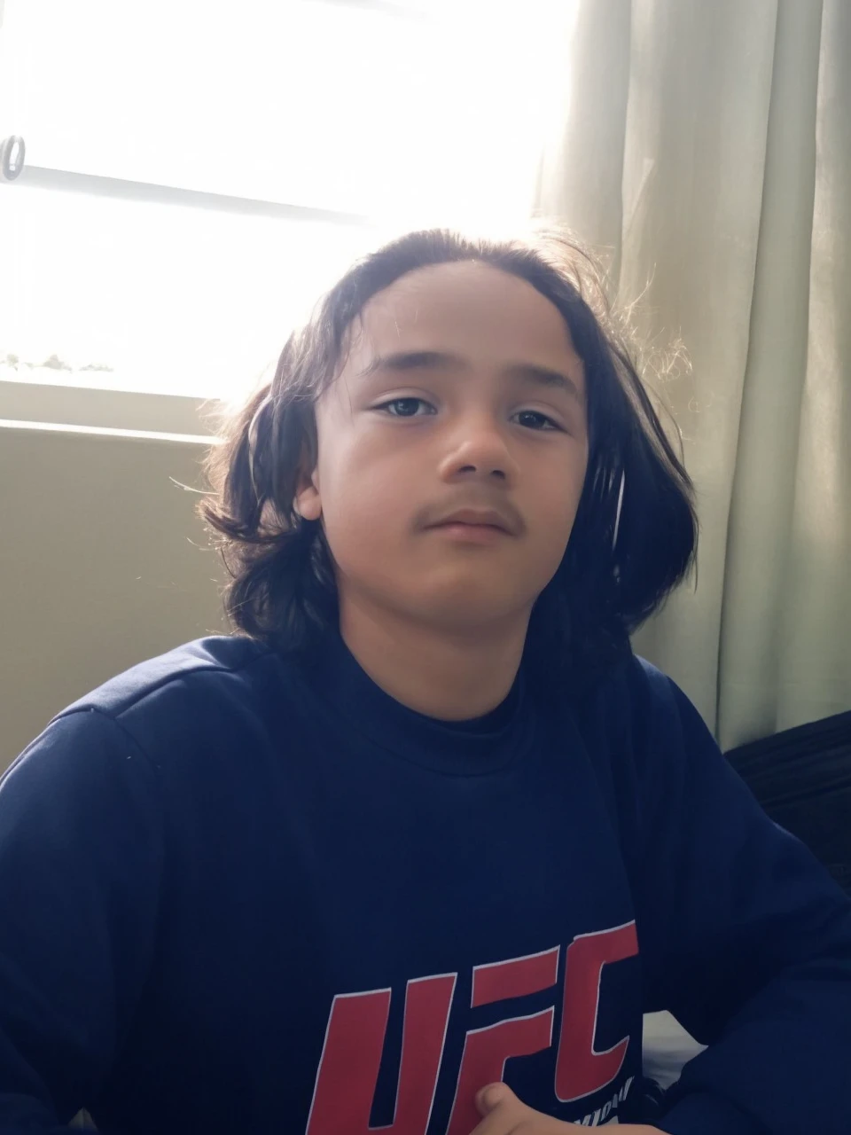 A boy with long black hair 