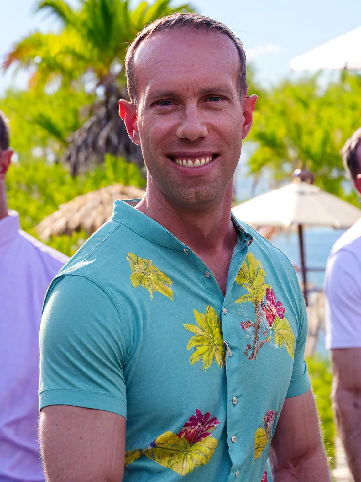 a man, Todder8, Todder1 short hair, perfect skin, RAW, UHD, 8K, looking at camera, on a yacht at sea, vacation photography, island paradise, colorful Hawaiian shirt, photorealistic, dynamic lighting, perfect day, [smiling]