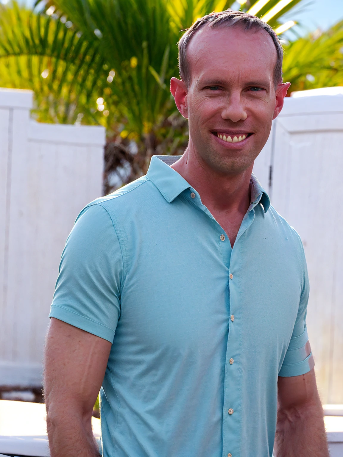 a man, Todder8, Todder1 short hair, perfect skin, RAW, UHD, 8K, looking at camera, on a yacht at sea, vacation photography, island paradise, colorful Hawaiian shirt, photorealistic, dynamic lighting, perfect day, [smiling]