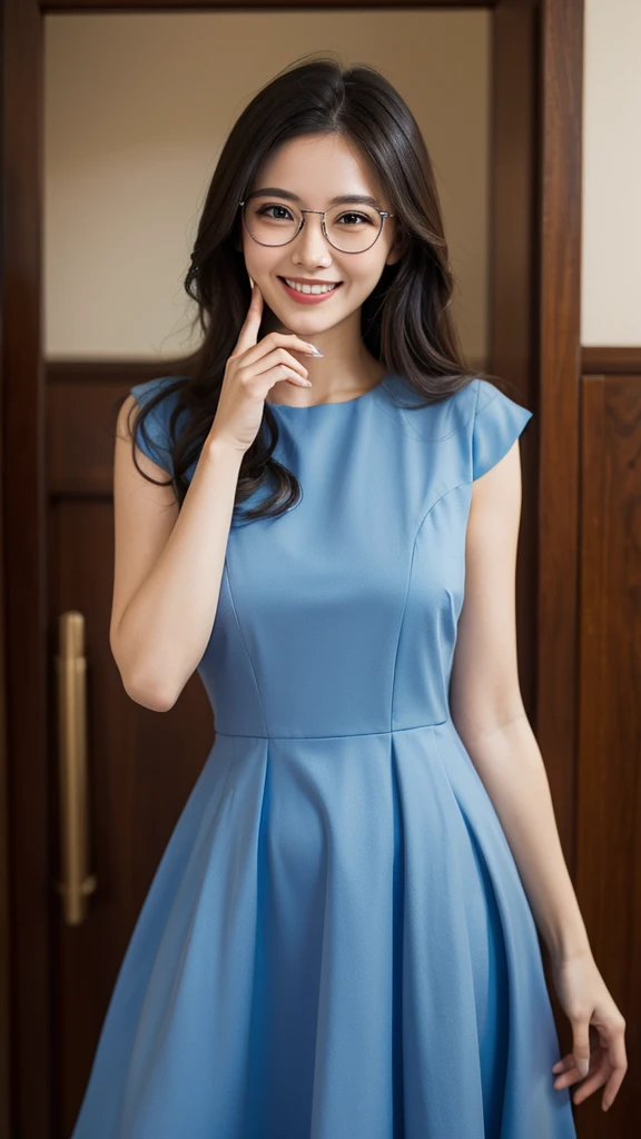A woman wearing glasses in a blue dress. Grinning.