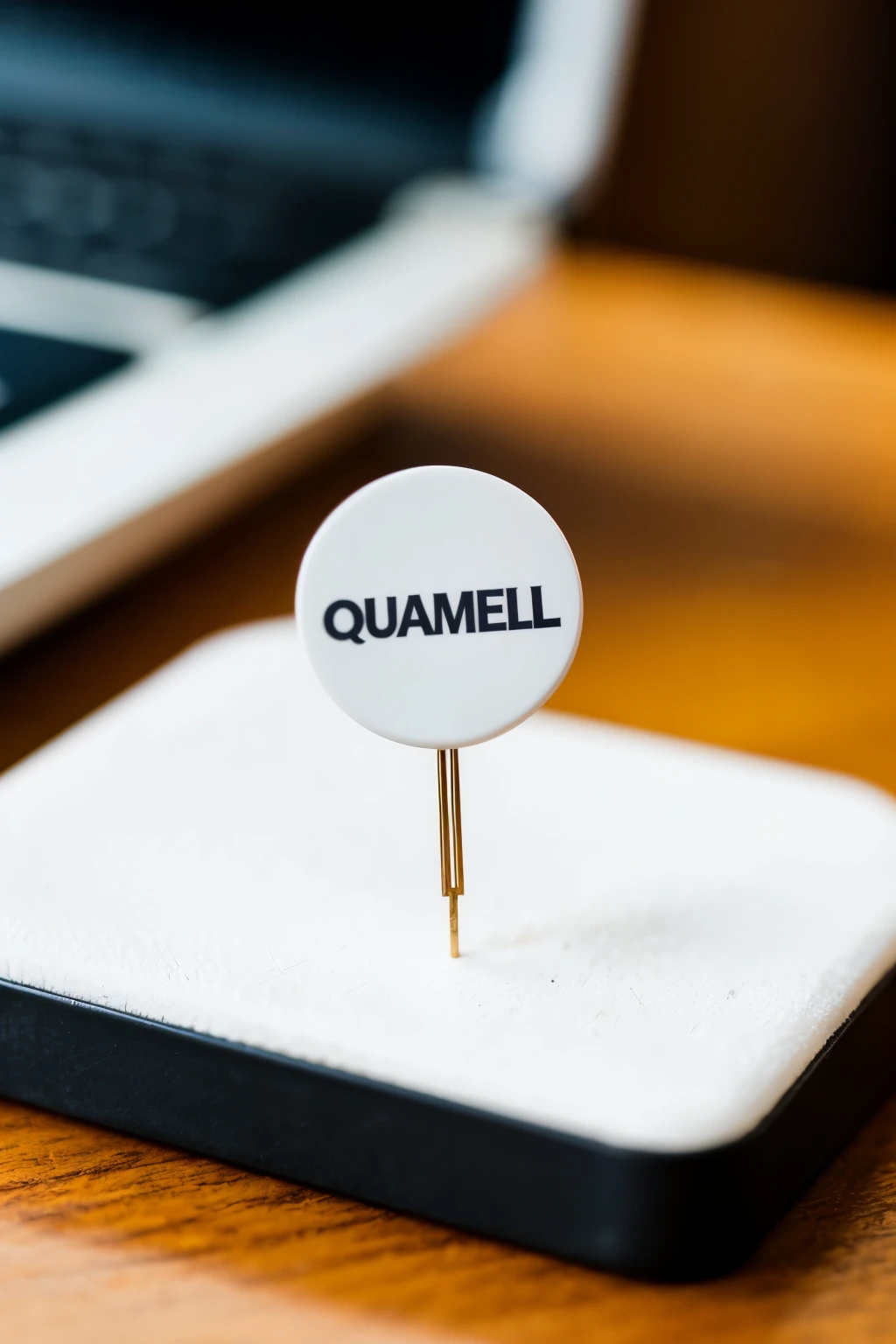 Model: of a white advertising pin, on top of a desk