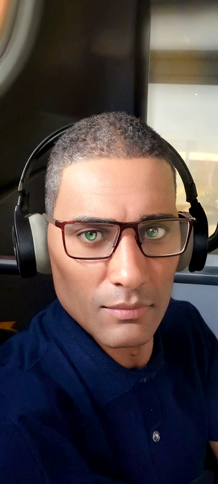 a dark-skinned man, 40 years old, wearing headphones, has green eyes, inside a bus, transparent glasses with brown frames, no beard, short hair, disney pixar art style, 3d render, photorealistic, cinematic lighting, highly detailed, intricate, masterpiece