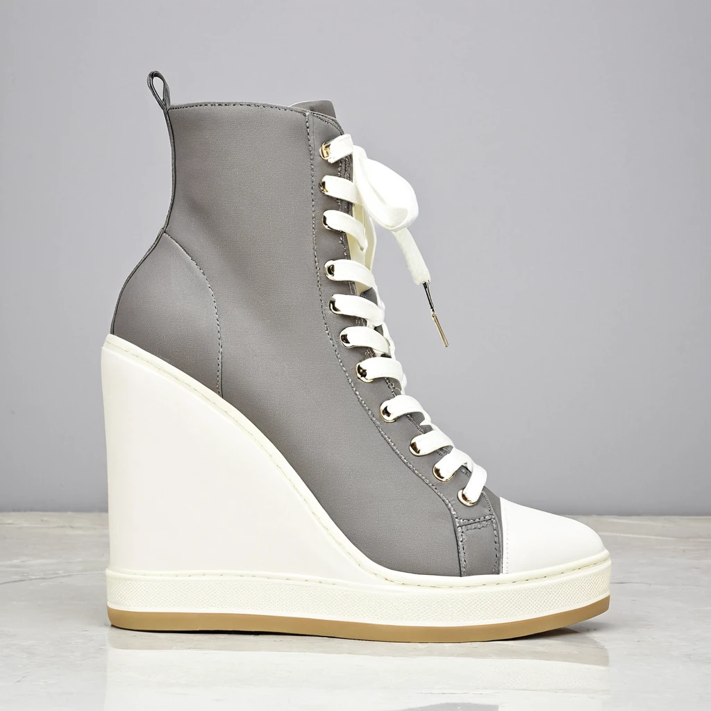 a shop window display, featuring pairs of women dancer's trainers. custom high top trainers. dainty pointed toe. reinforced very high top. grey and cream colour. chunky heel. zip fastening, front zip. 