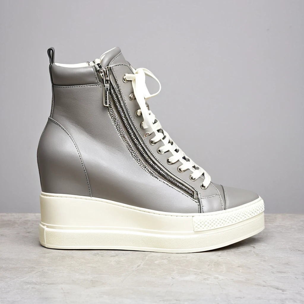 a shop window display, featuring pairs of women dancer's trainers. custom high top trainers. dainty pointed toe. reinforced very high top. grey and cream colour. chunky heel. zip fastening, front zip. 