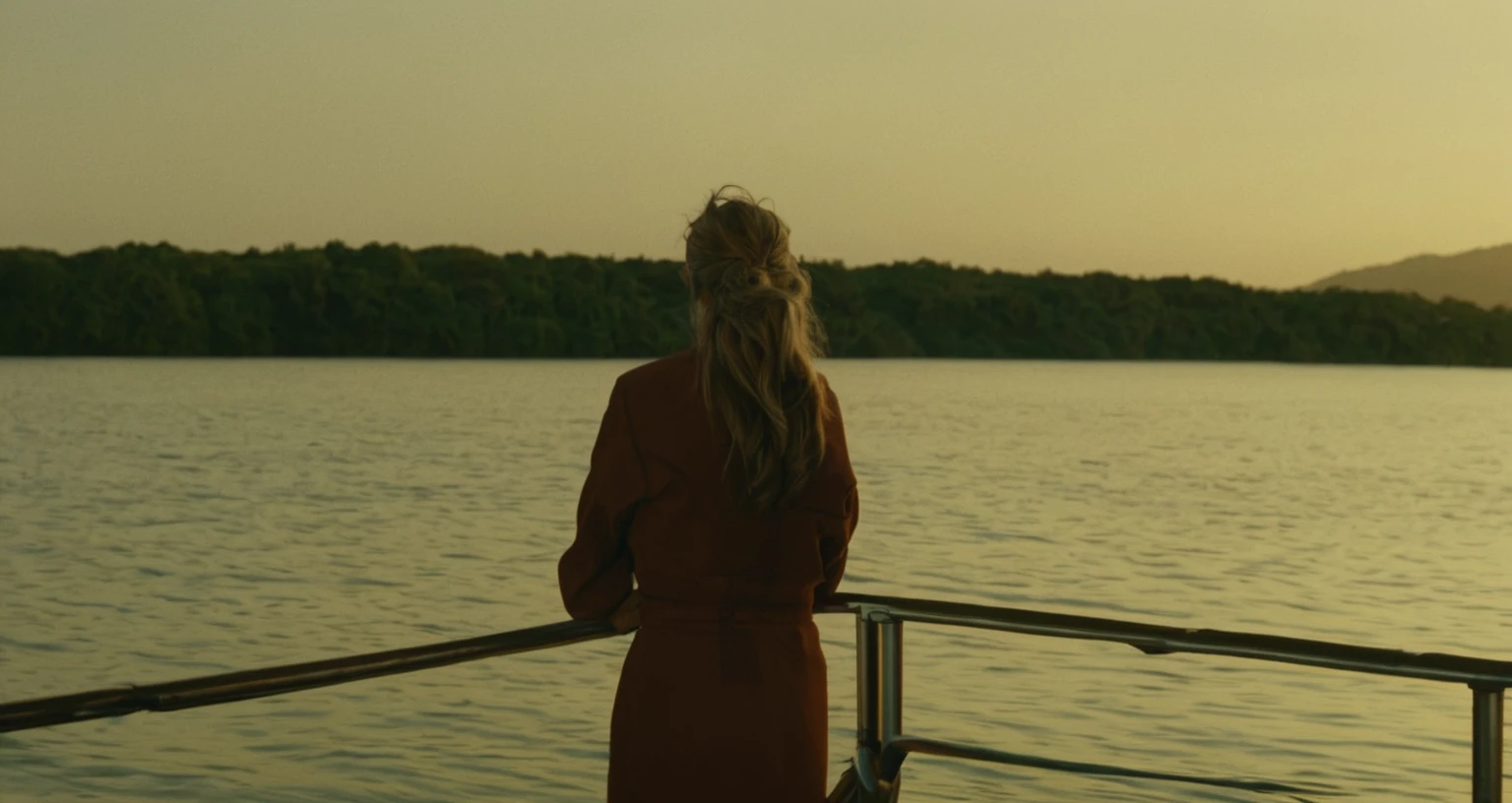 there is a woman standing on a boat looking out at the water, movie still
