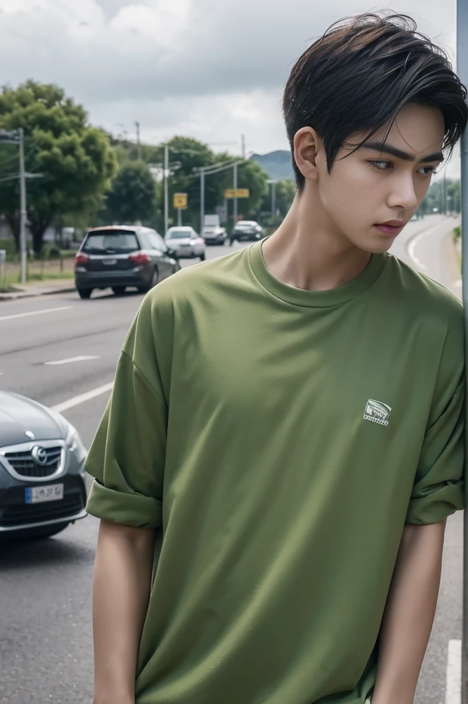 Young man in a green shirt Standing on the roadside with a serious expression, looking into the distance,Eyebrows frowned.,He looked worried.,Turn your head slightly.,Cloudy day, coffee shop