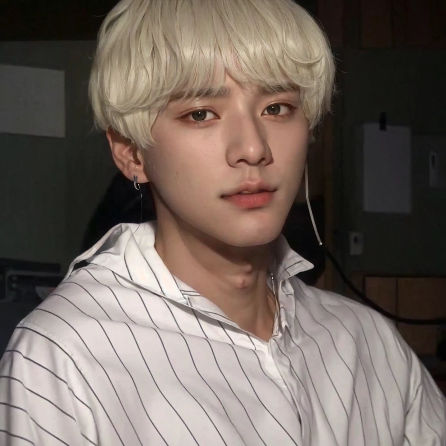 arafed male in a white shirt with a white shirt and earphones, taehyung eating gucci fries, hyung tae, kim doyoung, bts, white bangs, his eyes look wise, hair whitebangs hair, taejune kim, in white clothes, with short hair, white haired, he has dark grey hairs, jimin\'s right eyelid swollen