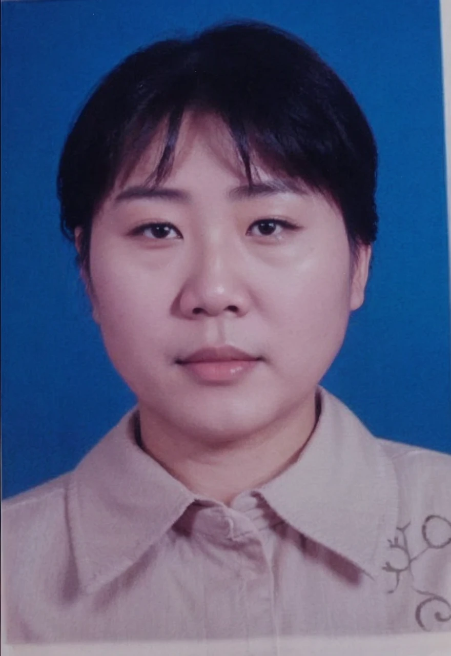 An old Chinese teacher wearing black blazer with white shirt