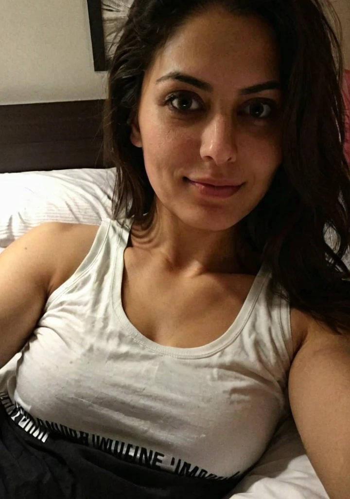 iphone night mode photo, pretty punjabi mom, fair white skin, lying in bed, takig selfie, at night, in a low neck tank top, low light, dark photo, dimly lit, extreme close-up