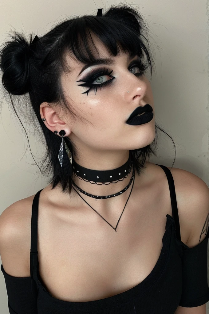 a person with a unique alternative aesthetic. They have dark hair styled with two buns on the top of their head and straight bangs across their forehead. The individual's eyes are a soft green, and they wear dramatic black lipstick. They have a septum piercing and multiple earrings in one ear. Their makeup is notable for the winged eyeliner, and there are artistic black streaks or smudges on their right cheek, adding an edgy touch. They wear a black t-shirt with a graphic design visible at the neckline, and their look is accessorized with a black choker and layered necklaces. The backdrop has a marbled or mottled texture in grayish tones, which complements the dark hues of their outfit and makeup.  g0thg1rl