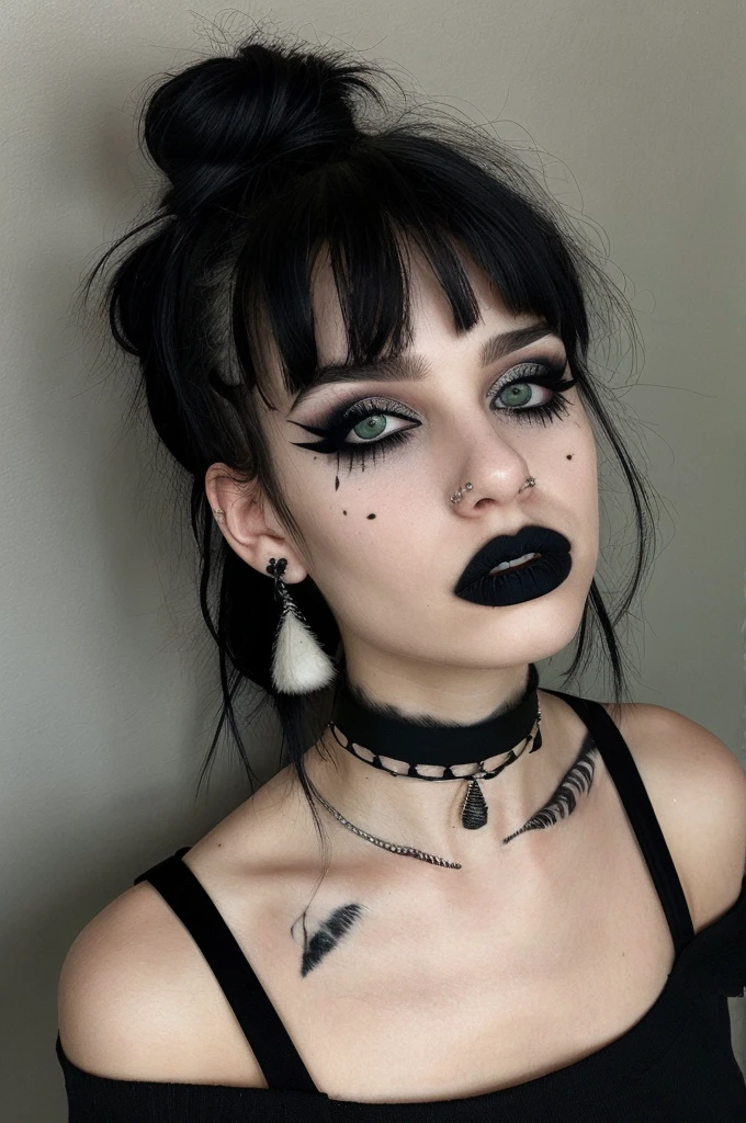 a person with a unique alternative aesthetic. They have dark hair styled with two buns on the top of their head and straight bangs across their forehead. The individual's eyes are a soft green, and they wear dramatic black lipstick. They have a septum piercing and multiple earrings in one ear. Their makeup is notable for the winged eyeliner, and there are artistic black streaks or smudges on their right cheek, adding an edgy touch. They wear a black t-shirt with a graphic design visible at the neckline, and their look is accessorized with a black choker and layered necklaces. The backdrop has a marbled or mottled texture in grayish tones, which complements the dark hues of their outfit and makeup.  g0thg1rl