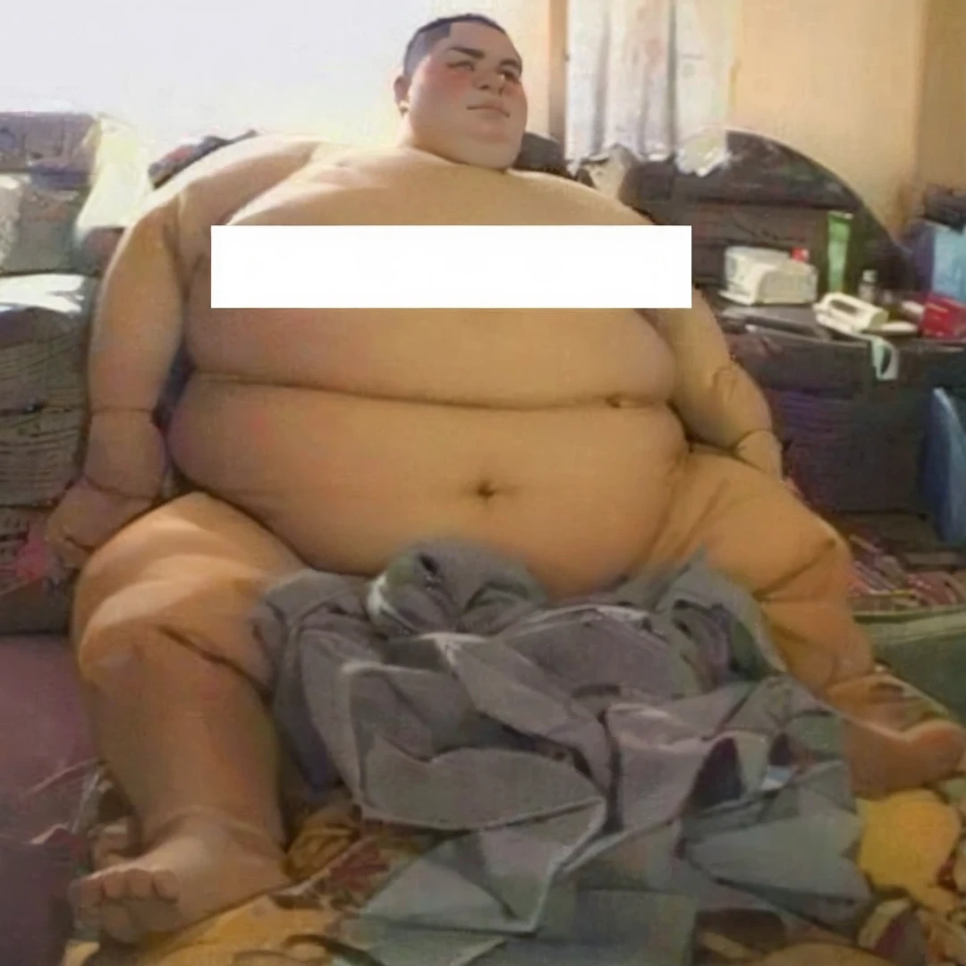 Obese boy sitting on a sofa.