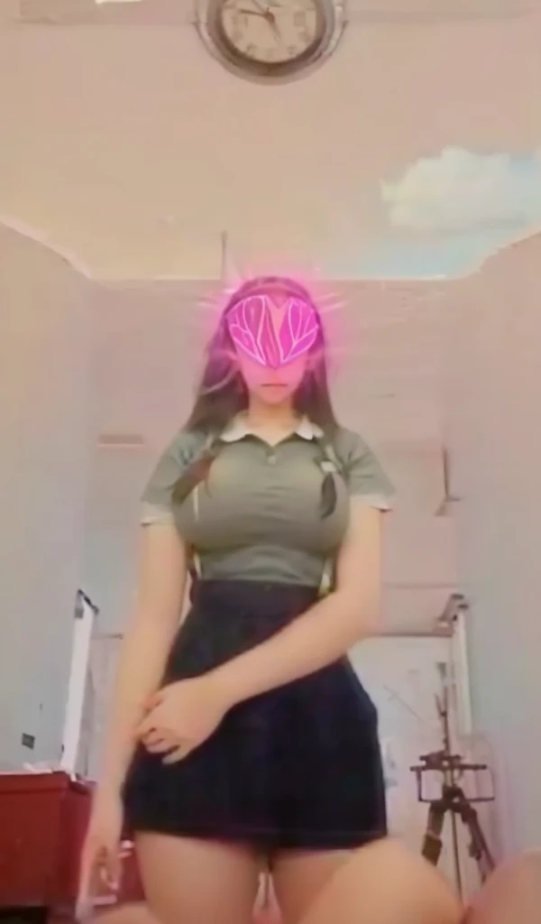 A 13 year old woman shows off her genitals and large breasts.