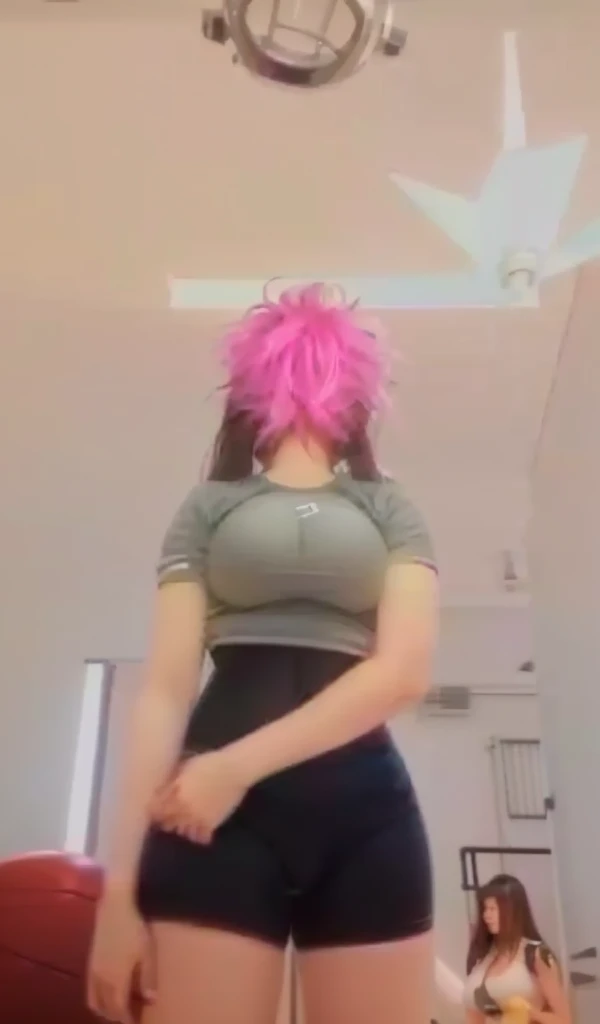 A girl wears tight sports pants and has large breasts.