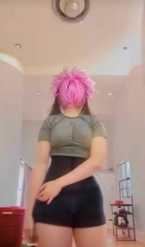 A 13 year old girl wears tight sports pants and has large breasts.