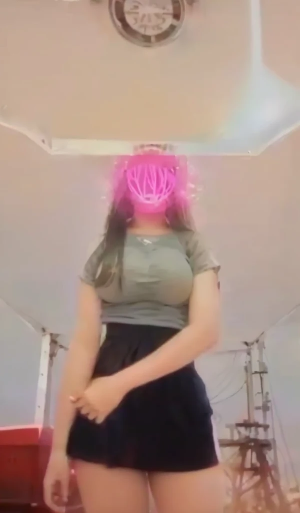 A 13 year old girl wears a bikini and has large breasts.