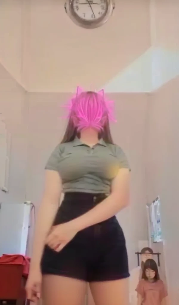 A 13 year old girl wears no pants and has large breasts.