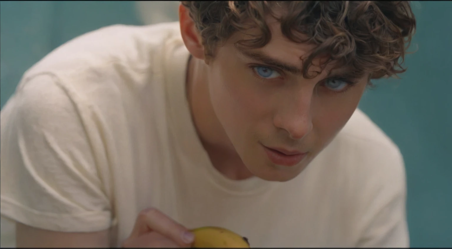 There was a young man holding a banana in his hand, Pretty Boy, Timothy Chalamet, his frank blue eyes, YouTube 视频screenshot, 音乐视频screenshot, a24 Cinematography, Declan McKenna, screenshot, High-quality movie stills, a24!Cinematography, he has short curly brown hair, screenshot, tyler