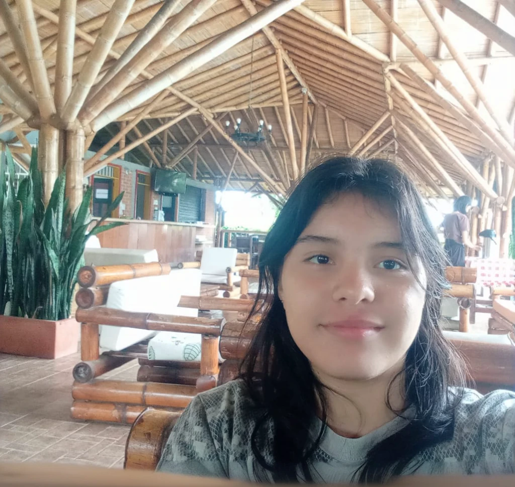 there is a woman taking a selfie in a restaurant, without makeup, slightly smiling, Inside image, in the midst of nature, taken with the best dlsr camera, frontal photo, inside shot, with mountains in the background, ayahuasca, selfie of a young woman, very slightly smiling, taken on go pro hero8, with a friendly face, try it, indoor environment