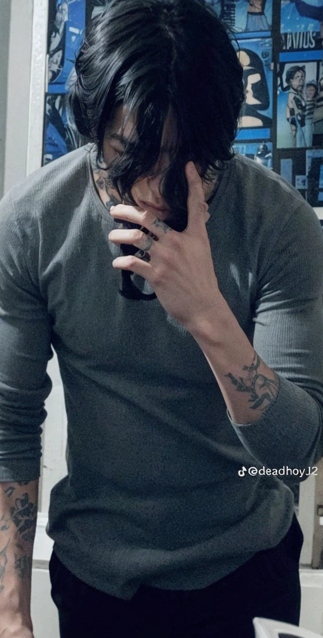 a handsome boy, high, black hair, tattooed, muscular, with a dull blue t-shirt and black pants
