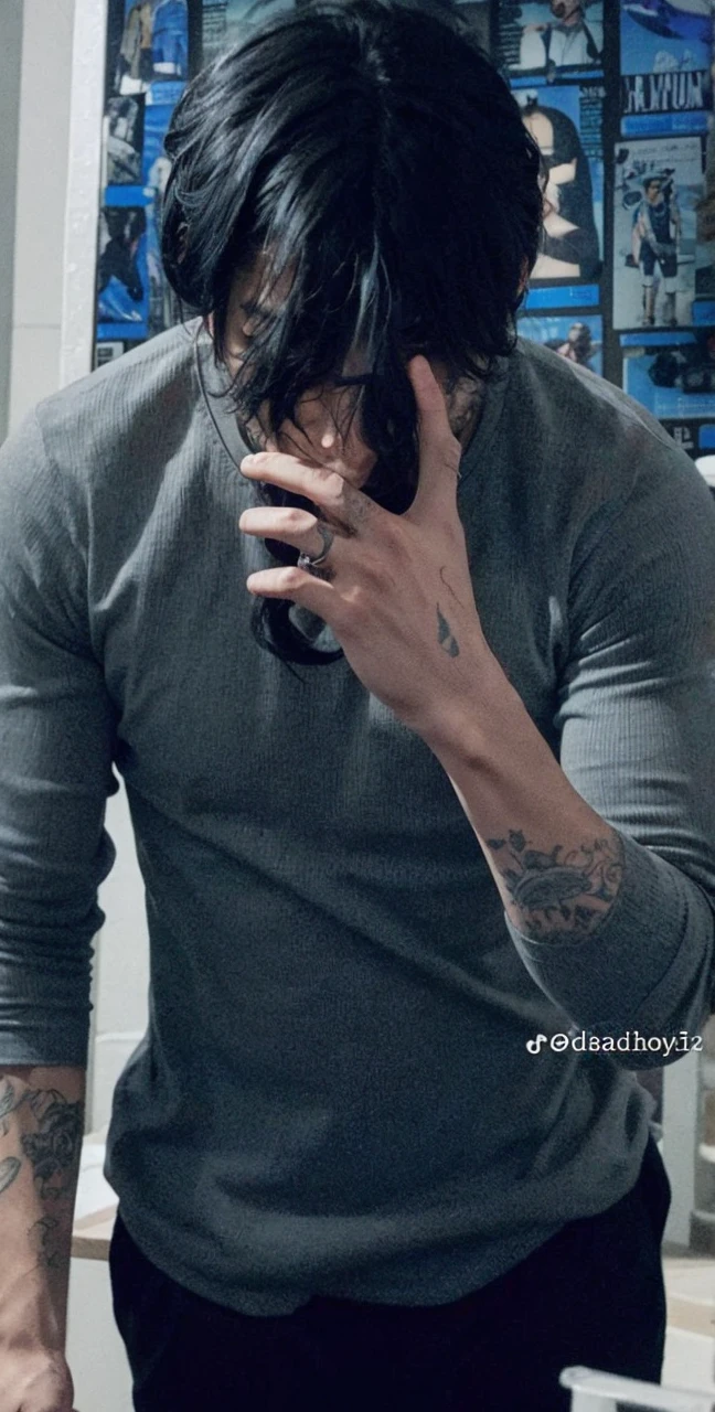 a handsome boy, high, black hair, tattooed, muscular, with a dull blue t-shirt and black pants