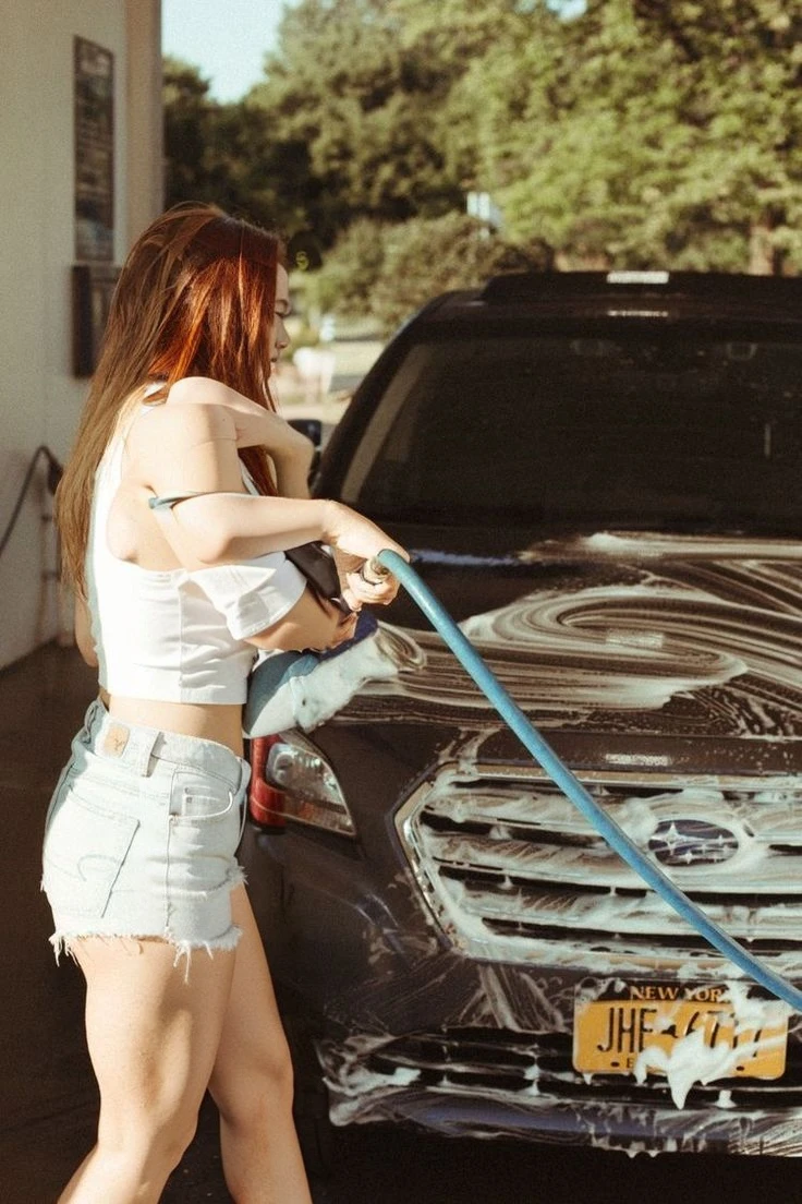 25-year-old girl ,girl with long red hair,a white top, very short black shorts, black shoes
