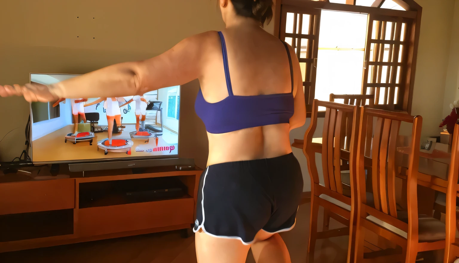 woman in blue top and black shorts playing wii in living room, toned derriere, rear-shot, back - shot, back shot, shot from the back, back pose, back view!!, backshot, view from the back, seen from the back, rear shot, back turned, from the back, long shot from back, long shot from the back