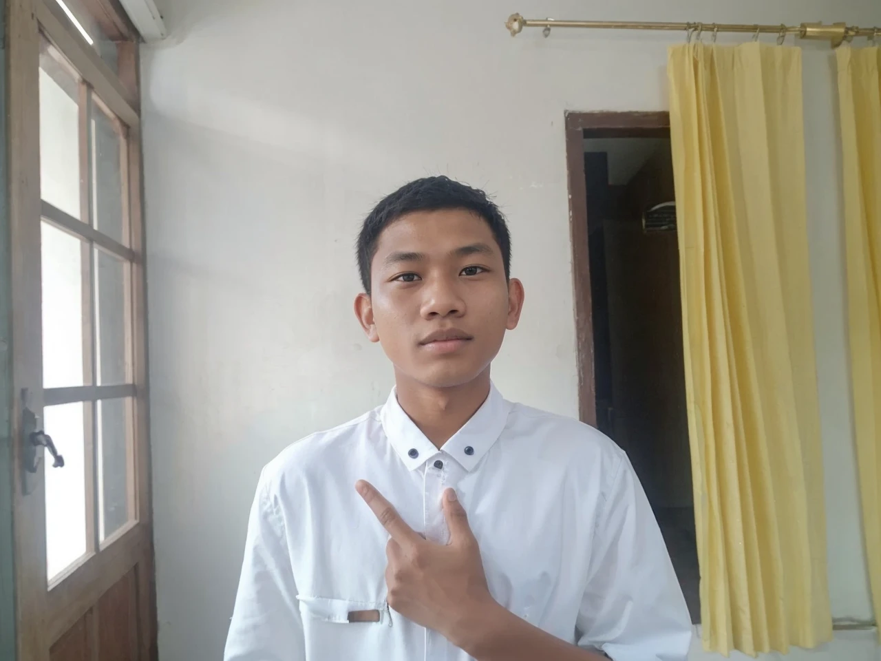Indonesian teenage boys. Age around 22 years. There is only one person in the photo. wearing a white jacket. The whole body is depicted facing forward. The background is a river in the forest.