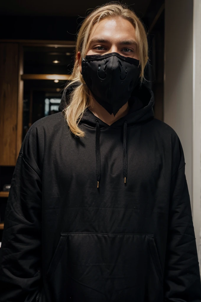 blonde haired man wearing a black devil mask
wearing a black and blue hoodie