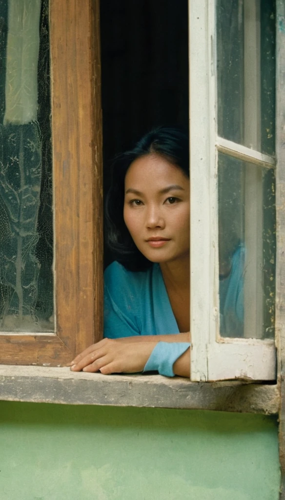 Long shot photo, very low angle shot, A shot taken from (((outside the window))) of a beautiful young asian woman in the 1970s, with her hair and clothing from the 1970s, the woman is sitting inside a humble 1970s asian kitchen looking out through the window, the glass of the window is somewhat tarnished and dirty at the edges, the woman is looking straight at the camera with a lost look and a slight smile, (((the shot was taken from the outside of the house))), full color with a cinematographic lighting, high definition professional photography style ,photorealistic