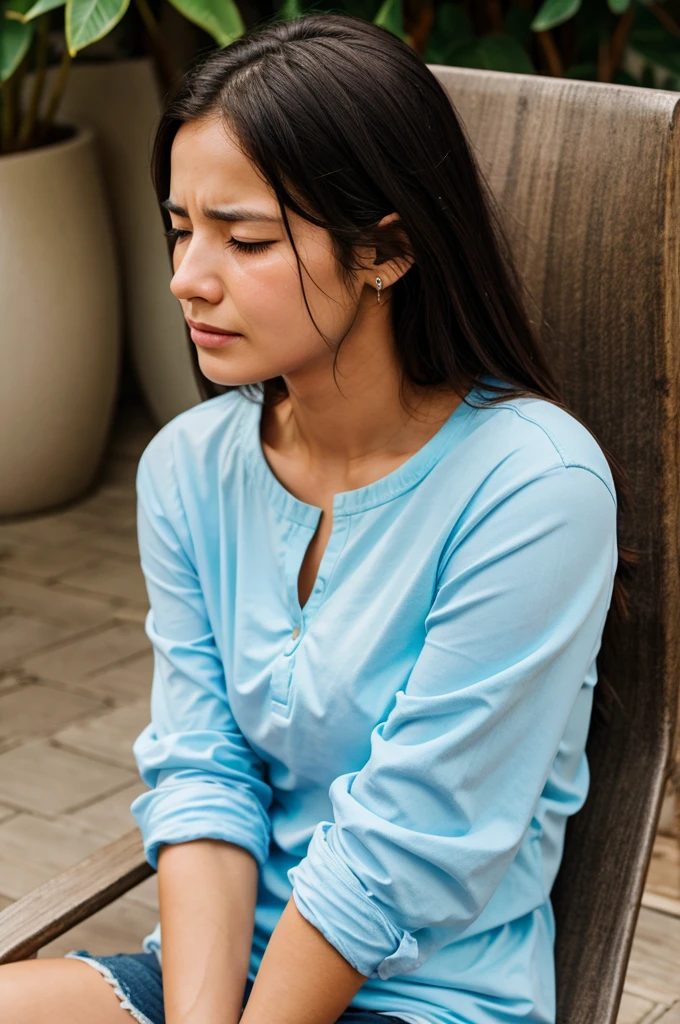 A woman sitting sadly and crying